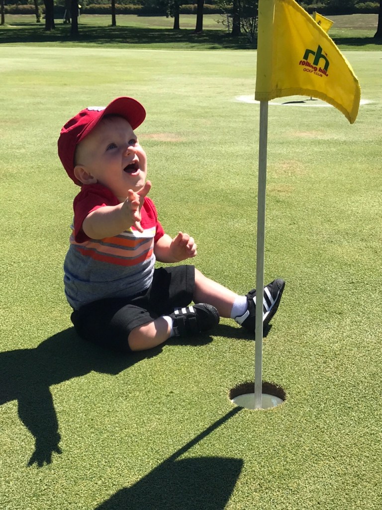 very young golfer having fun on the green